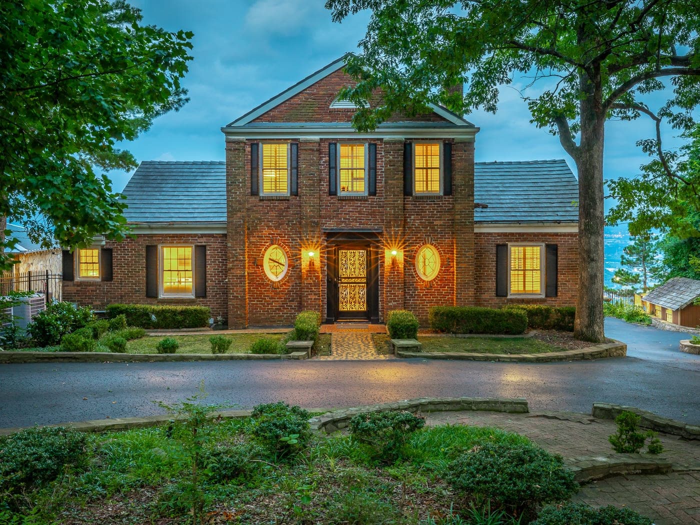 Brick colonial estate at twilight on Signal Mountain, represented by the Marsden Property Team